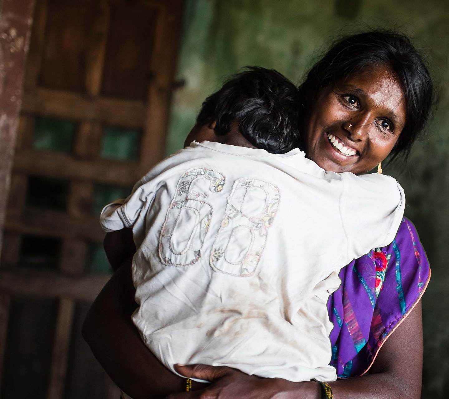 Asian mother cuddling her young child